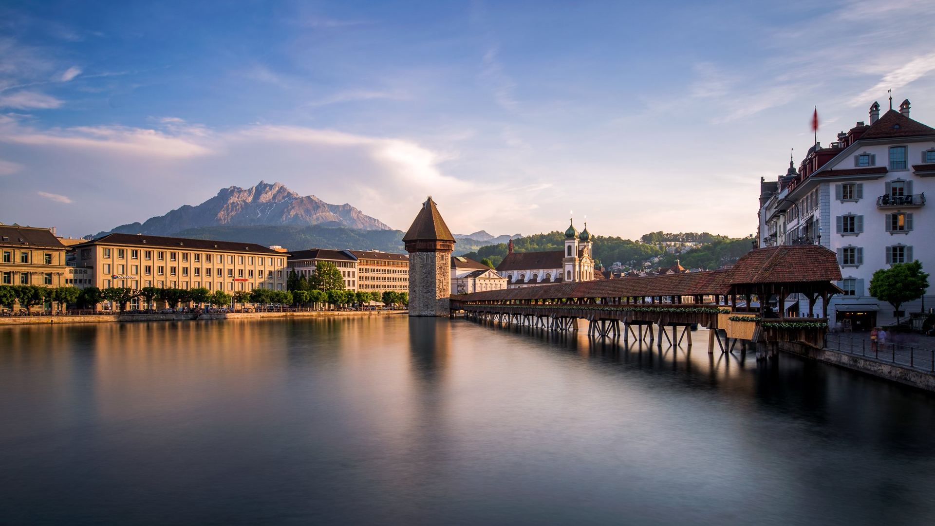 Lucerne's Chapel Bridge over the Reuss river at sunset
